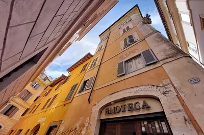 a yellow building with a sign on the side of it at Appartamento 