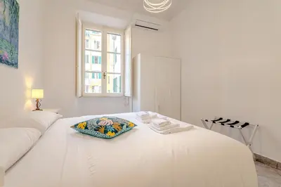 a white bedroom with a white bed and a window at Tomo Apartment St. Peter's in Rome