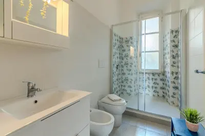 a bathroom with a sink and a toilet and a shower at Tomo Apartment St. Peter's in Rome