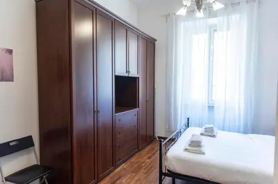 a bedroom with a large wooden cabinet with a tv at A due passi dal Vaticano in Rome