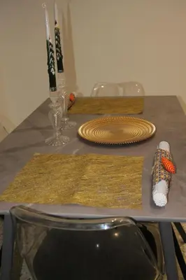 a table with two place mats and plates on it at Appartamento Hector in Rome