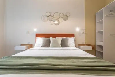 a bedroom with a large bed with a green blanket at CORNELIA COZY&ELEGANCE FLAT in Rome