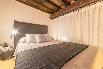 a bedroom with a large bed with a large window at Campo De' Fiori 35 (Centro di Roma/Appartamento accogliente) - FromhometoRome in Rome
