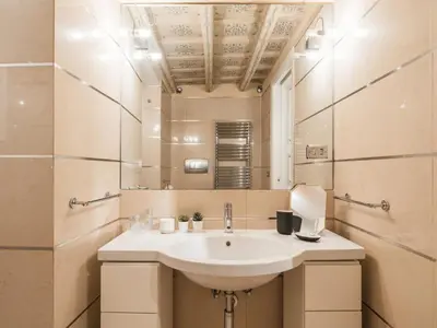a bathroom with a sink and a mirror at The Best Rent - Spacious two-bedroom apartment in old town in Rome