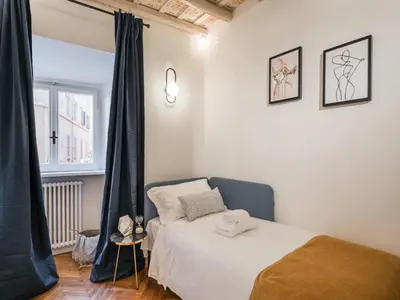 a bedroom with a bed and a window at The Best Rent - Spacious two-bedroom apartment in old town in Rome