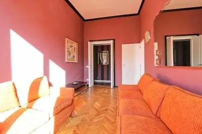 a living room with red walls and a couch at Tibullo ,Classico ed Elegante Appartamento in Rome