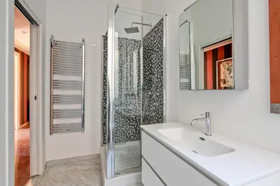 a white bathroom with a sink and a shower at Tibullo ,Classico ed Elegante Appartamento in Rome