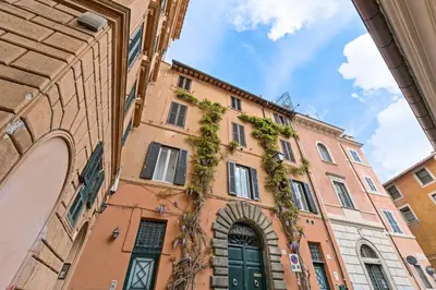 a building with plants on the side of it at Rome As You Feel - Santo Stefano in Rome