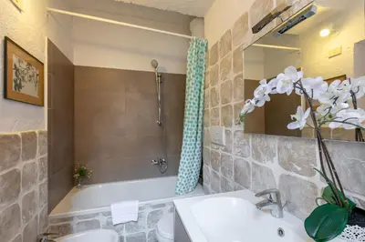 a bathroom with a sink and a bath tub with a shower at Rome As You Feel - Santo Stefano in Rome