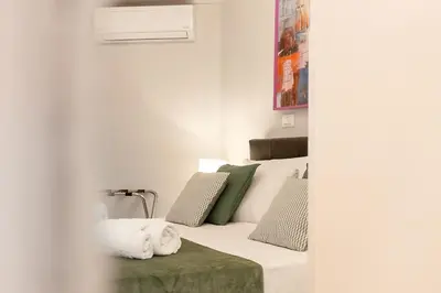 a room with a guitar and a bed at Crispi 30 Stylish Apartment in Rome