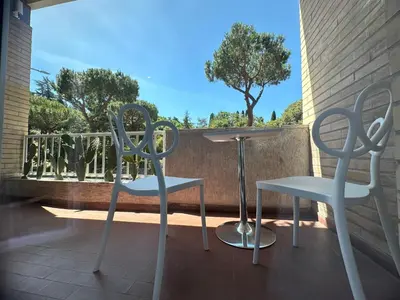 two chairs and a table on a balcony at St.Peter's Moon in Rome
