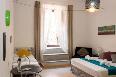 a small room with two beds and a window at ArtHouse Termini in Rome