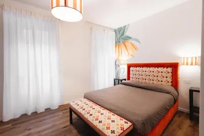 a bedroom with a bed and white curtains at Famo Pace apartments in Rome