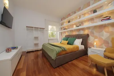 a bedroom with a bed and a desk and a television at YCH-Stylish 3 bedrooms apartment near Vatican in Rome