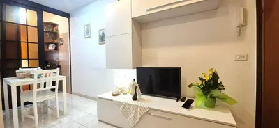 a living room with a flat screen tv on a table at A casa di chi, Family, Near Metro in Rome
