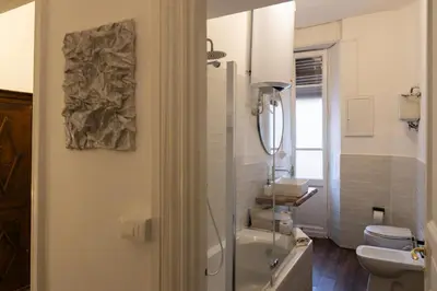 a bathroom with a sink and a toilet and a mirror at Giuliana Apartment Vatican in Rome