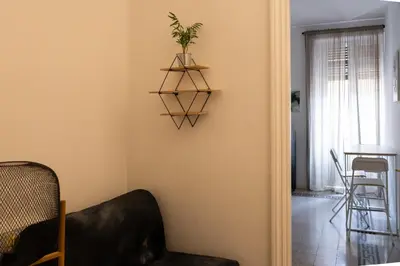 a living room with a plant on a shelf on the wall at Giuliana Apartment Vatican in Rome