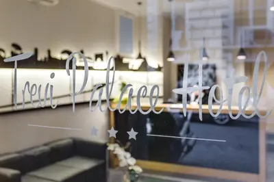 a window with the word salon written on it at Trevi Palace Hotel in Rome