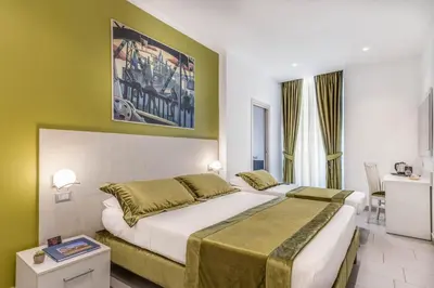 a bedroom with two beds and a painting on the wall at Trevi Palace Hotel in Rome