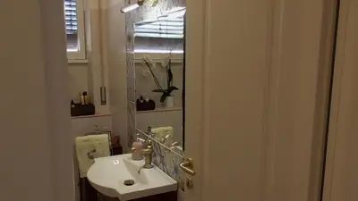 a bathroom with a sink and a mirror at Italian romance - A fine apartment in Rome in Rome