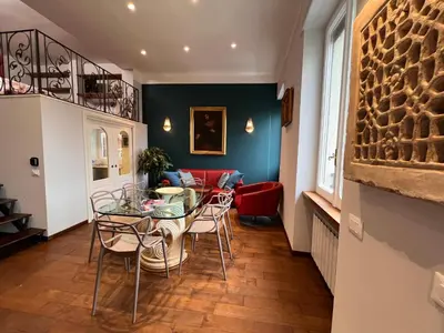 a dining room with a glass table and chairs at A Casa di Lu, al Colosseo - Guest House in Rome