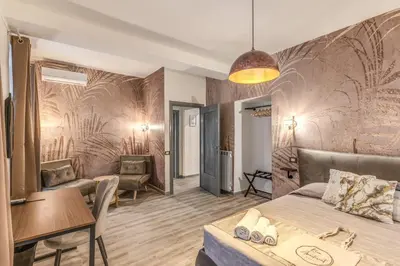 a room with a bed and a table and chairs at NALA & KIRA - Two big apartments for groups in the center of Rome in Rome