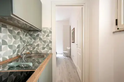 a kitchen with a sink and a hallway at Domus White in Rome