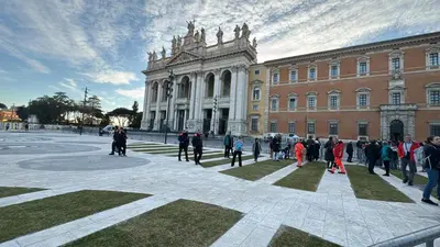 a group of people standing in front of a building at Cozy Suite Saint John in Rome