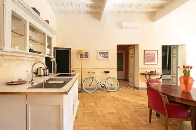 a kitchen with a table and a bike in a room at Farnese Designer Loft by Romeloft in Rome
