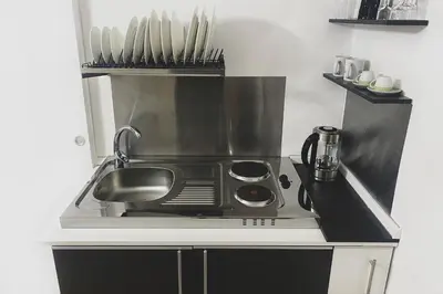 a kitchen with a sink and a microwave at Dea Clodia studio flat in Rome