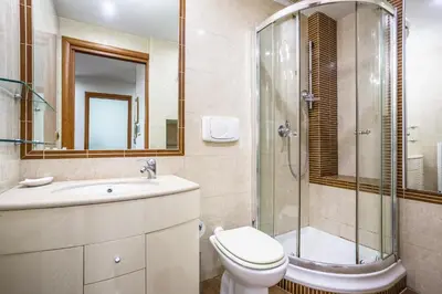 a bathroom with a toilet sink and a shower at Portside Aparthotel in Rome