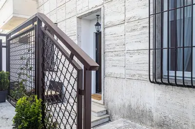 a staircase with a wrought iron fence next to a building at [Flaminio * * * * *] - Loft con Giardino in Rome