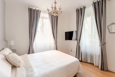a bedroom with a bed and a chandelier at In the shadow of the Colosseum in Rome