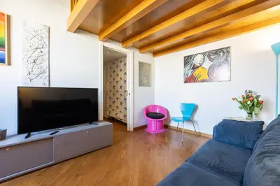 a living room with a couch and a flat screen tv at Colosseum bright two Bedroom Apartment in Rome
