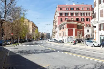 an empty street in a city with buildings at Colosseum bright two Bedroom Apartment in Rome