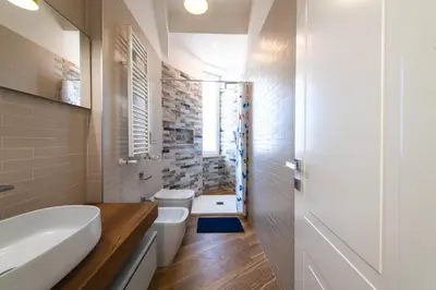 a bathroom with a tub and a toilet and a sink at Casa del Marchese del Grillo in Rome