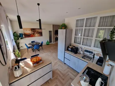 a kitchen with a refrigerator and a table in a room at Vacanze Romane Apartments - Vatican City in Rome