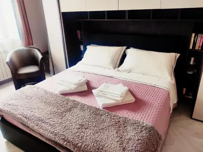 a bedroom with a bed with two towels on it at Portami a Roma in Rome