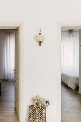 a hallway with a door to a bedroom with a bed at Casa Riva 1920 in Rome