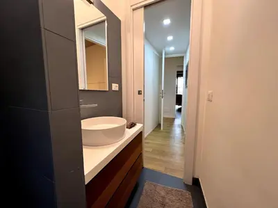 a bathroom with a white sink and a mirror at La Casa del giornalista - ItalyHolidayHouse in Rome