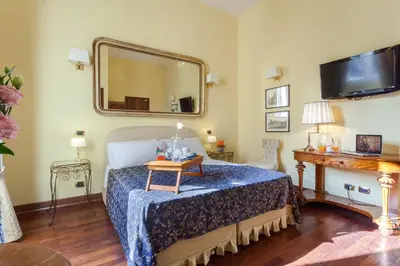 a bedroom with a bed with a mirror and a table at Vatican Domus in Rome
