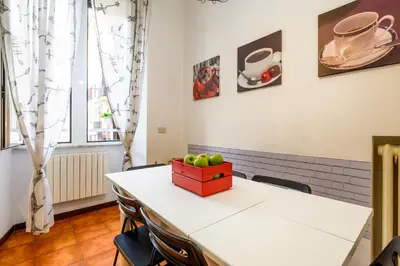 a table with chairs and a box of apples on it at Suite Apartment Prati in Rome