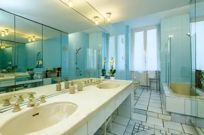 a bathroom with two sinks and a large mirror at Suite Apartment Prati in Rome