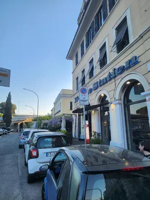 a row of parked cars parked in front of a building at corso francia suite in Rome