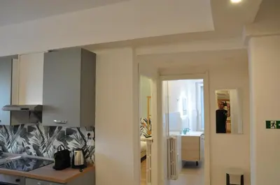 a kitchen with white cabinets and a counter top at corso francia suite in Rome