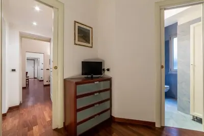 a room with a dresser with a television on it at GuestHost - A due passi da Santa Maria Maggiore Apartment in Rome