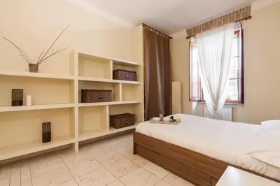 a bedroom with a large bed and a window at BORGO PIO - quite and spacious apt in Rome