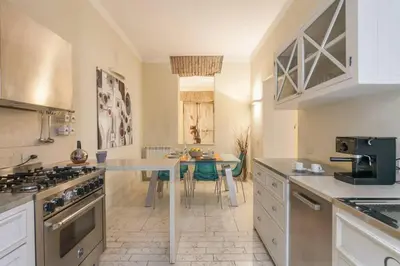 a kitchen with a table and a stove top oven at BORGO PIO - quite and spacious apt in Rome