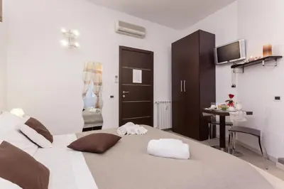 a bedroom with a large bed with towels on it at Relais 155 Guest House in Rome
