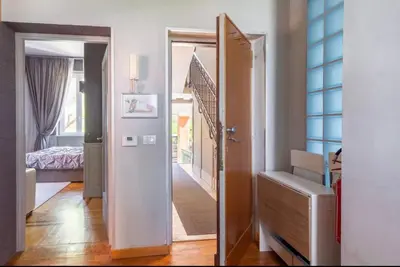 a hallway with a door leading to a bedroom at Vatican Home 51 in Rome